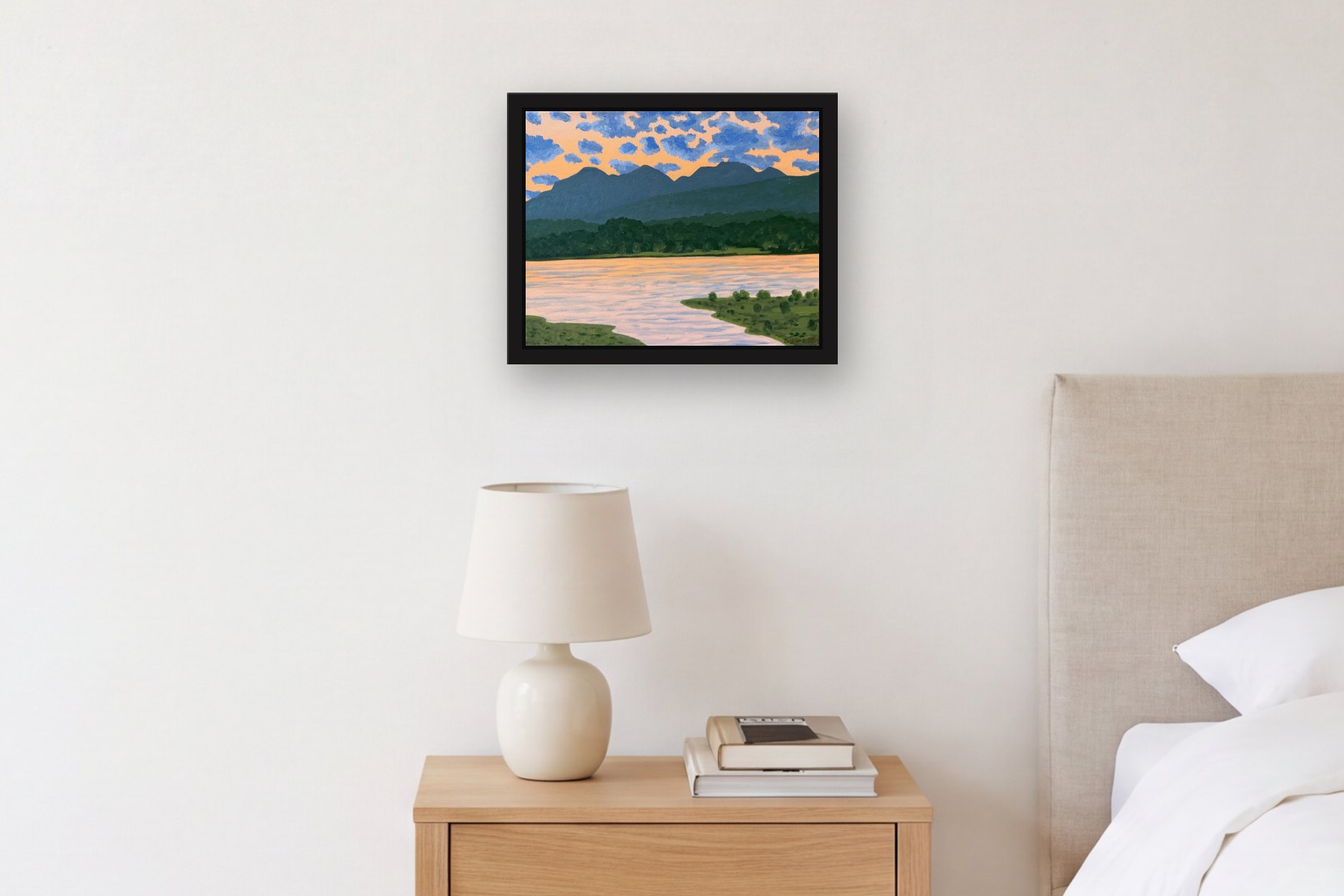The Catskills from Hudson at Twilight by Bill Sullivan, hanging above a bedside table in a bedroom
